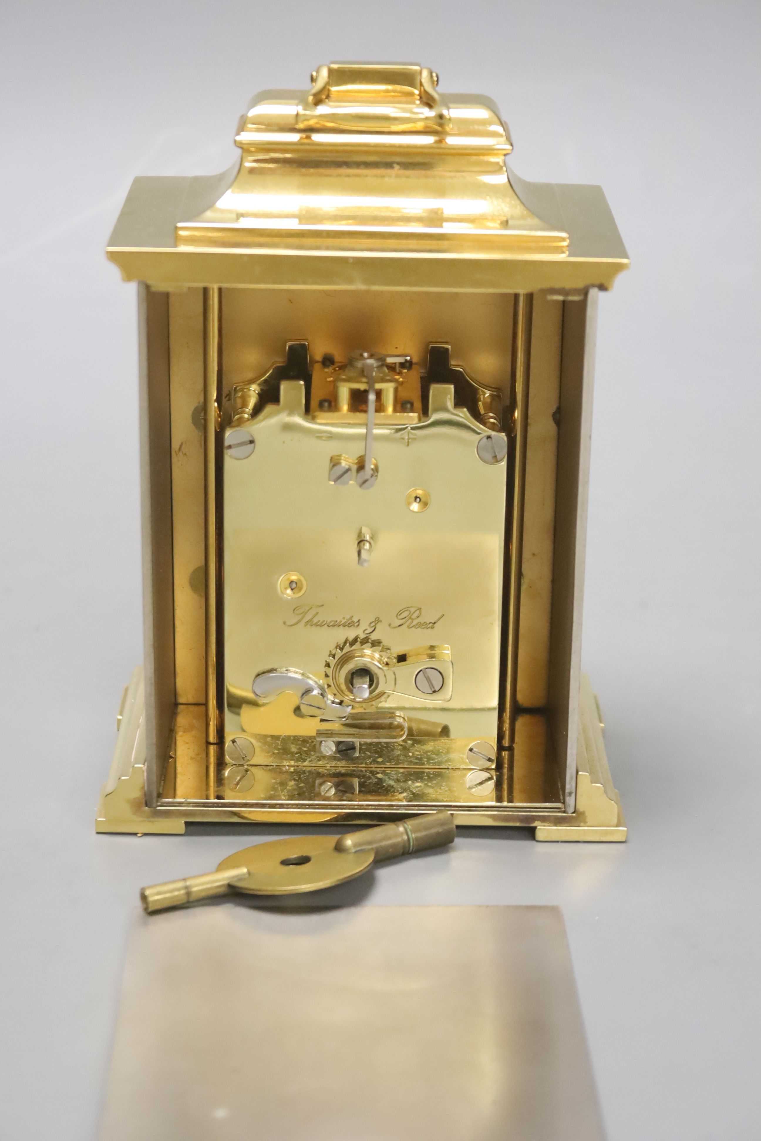 A small Georgian style silvered and gilt metal mantel timepiece by Thwaites & Reed, H 16cm